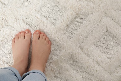 Photo of Woman standing on beige carpet, top view. Space for text