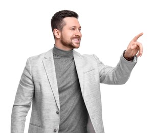 Handsome bearded businessman in suit pointing at something on white background