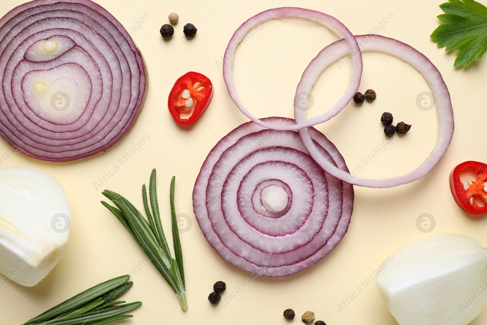 Photo of Flat lay composition with cut onion and spices on beige background