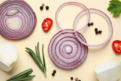 Photo of Flat lay composition with cut onion and spices on beige background