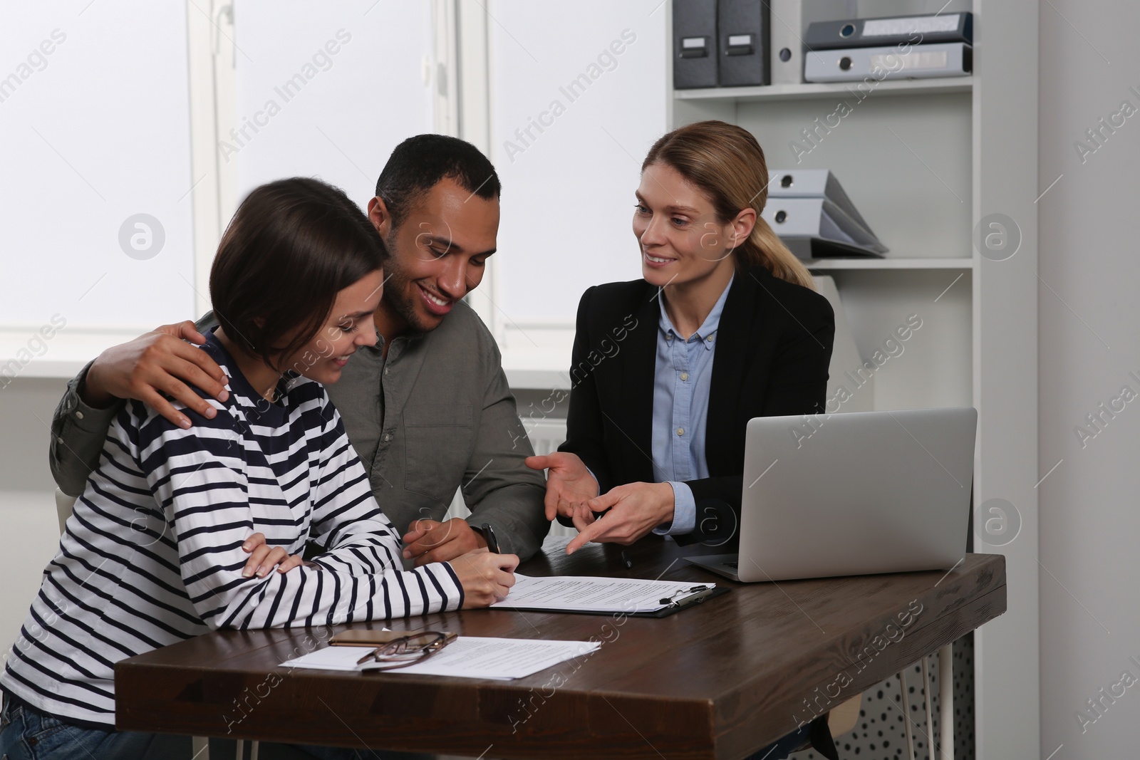 Photo of Couple consulting with professional notary in office