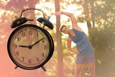 Workout time. Double exposure of man doing exercise on sunny morning in park and alarm clock, color toned