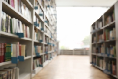 Photo of Blurred view of path between bookcases in library