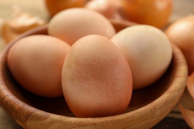 Easter eggs painted with natural dye in wooden bowl, closeup