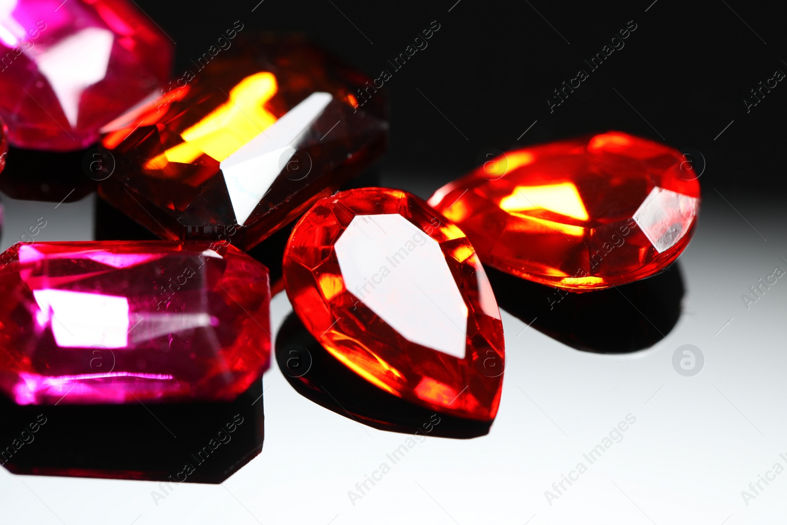 Photo of Beautiful gemstones for jewelry on dark background, closeup