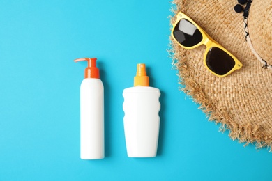 Photo of Flat lay composition with sun protection products on color background