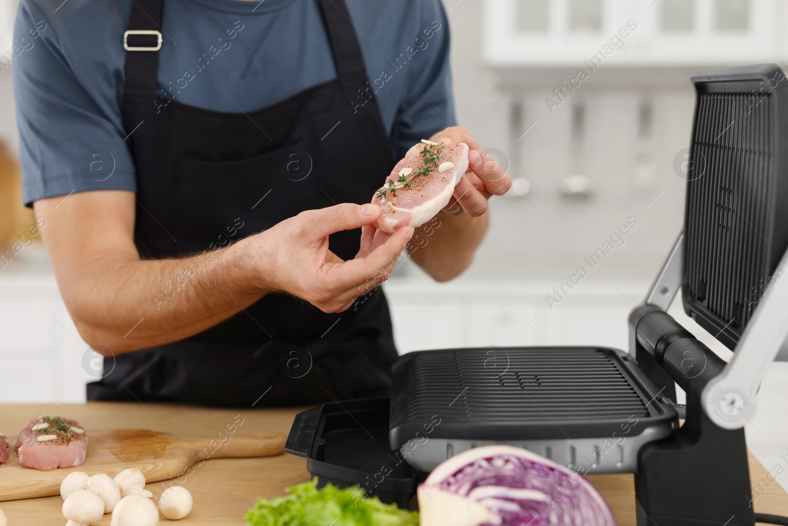 Photo of Man making dinner in kitchen, closeup. Online cooking course