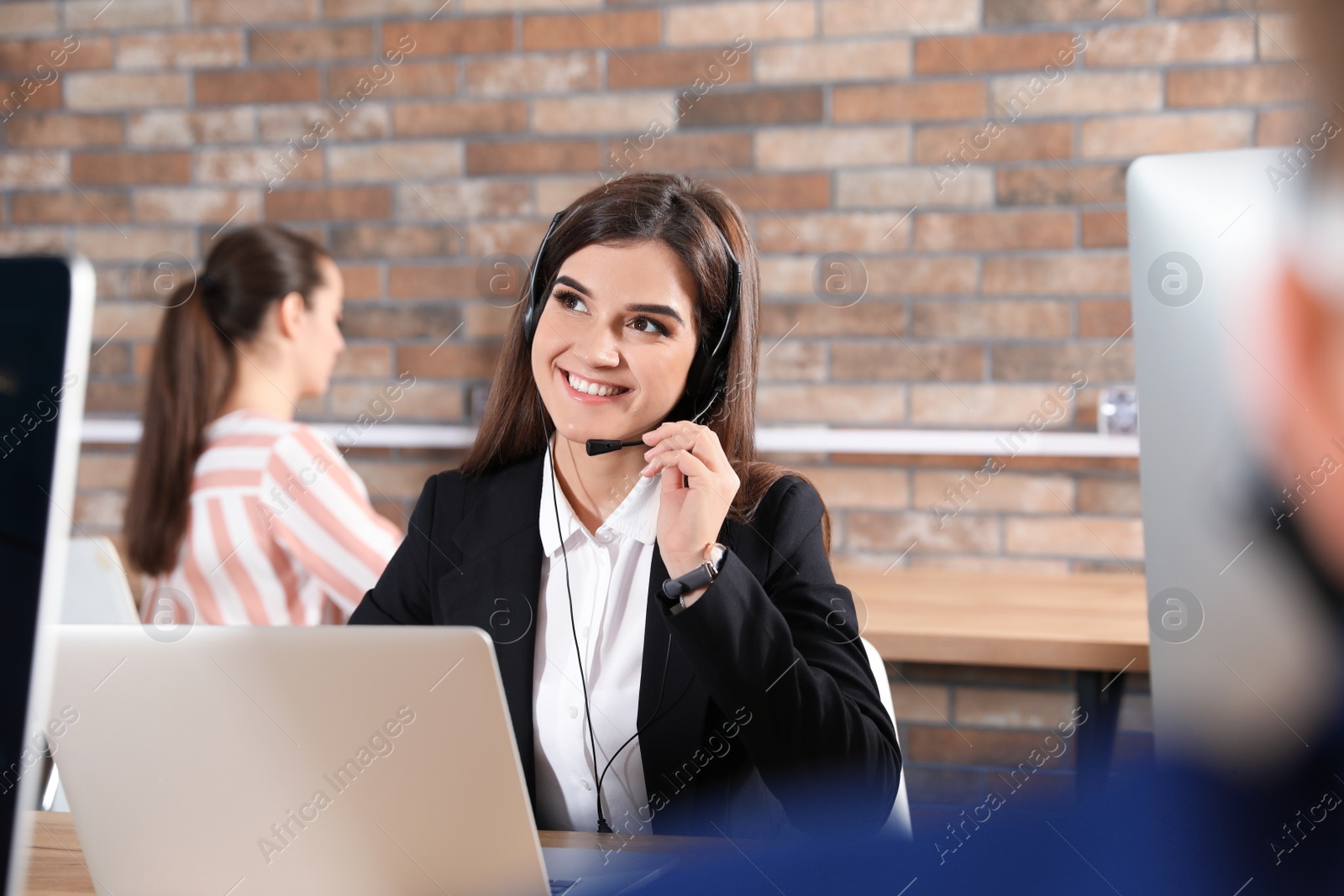 Photo of Technical support operator with headset in modern office