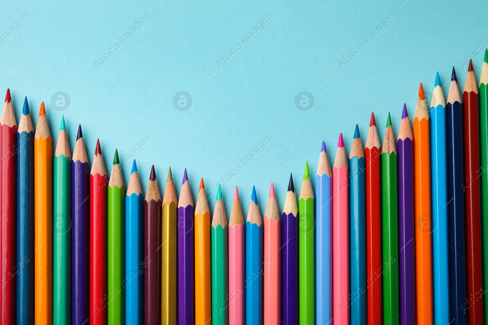 Photo of Flat lay composition with color pencils on blue background