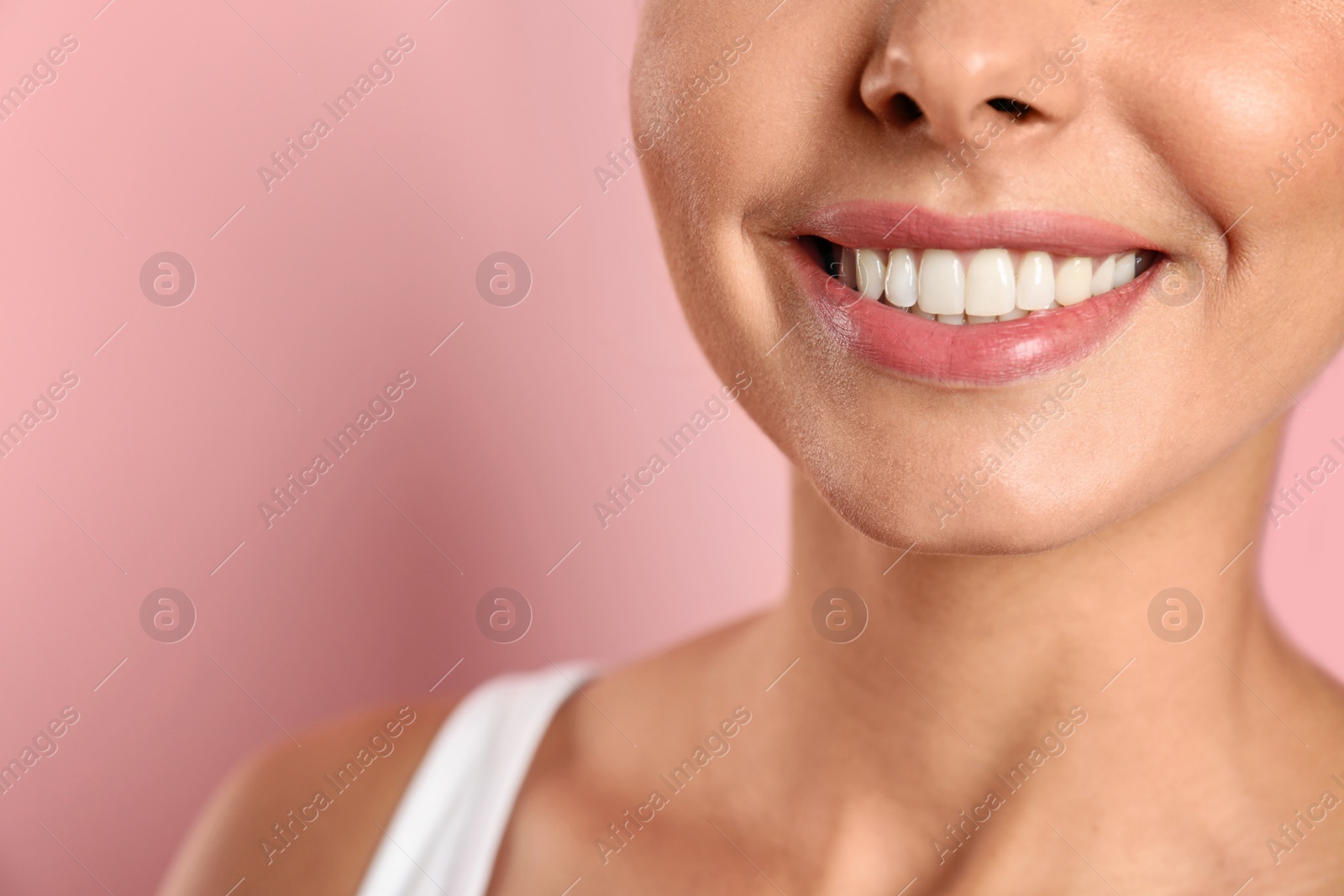 Photo of Young woman with healthy teeth on color background, closeup. Space for text