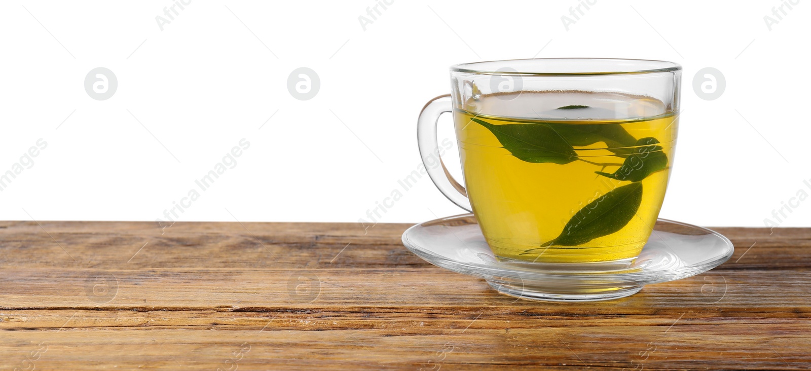 Photo of Refreshing green tea in cup on wooden table against white background