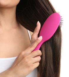 Photo of Woman with hair brush on white background, closeup