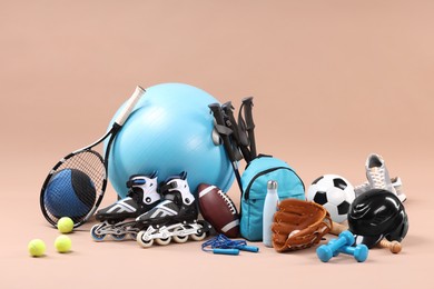 Many different sports equipment on beige background