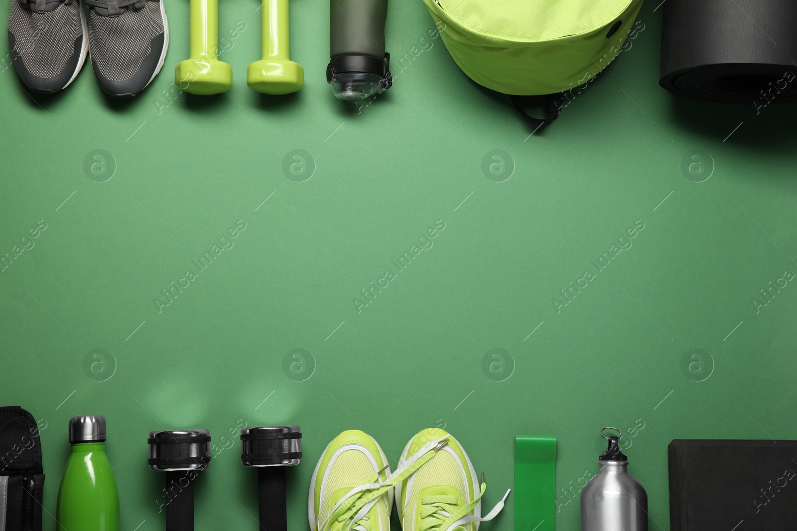 Photo of Frame made of different sports equipment on green background, flat lay. Space for text