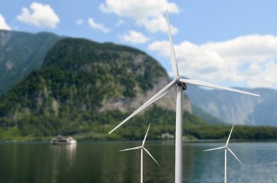 Alternative energy source. Wind turbines near mountains