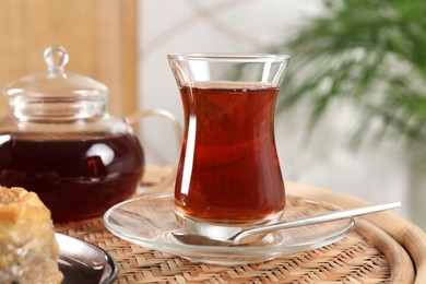 Traditional Turkish tea in glass on wicker table