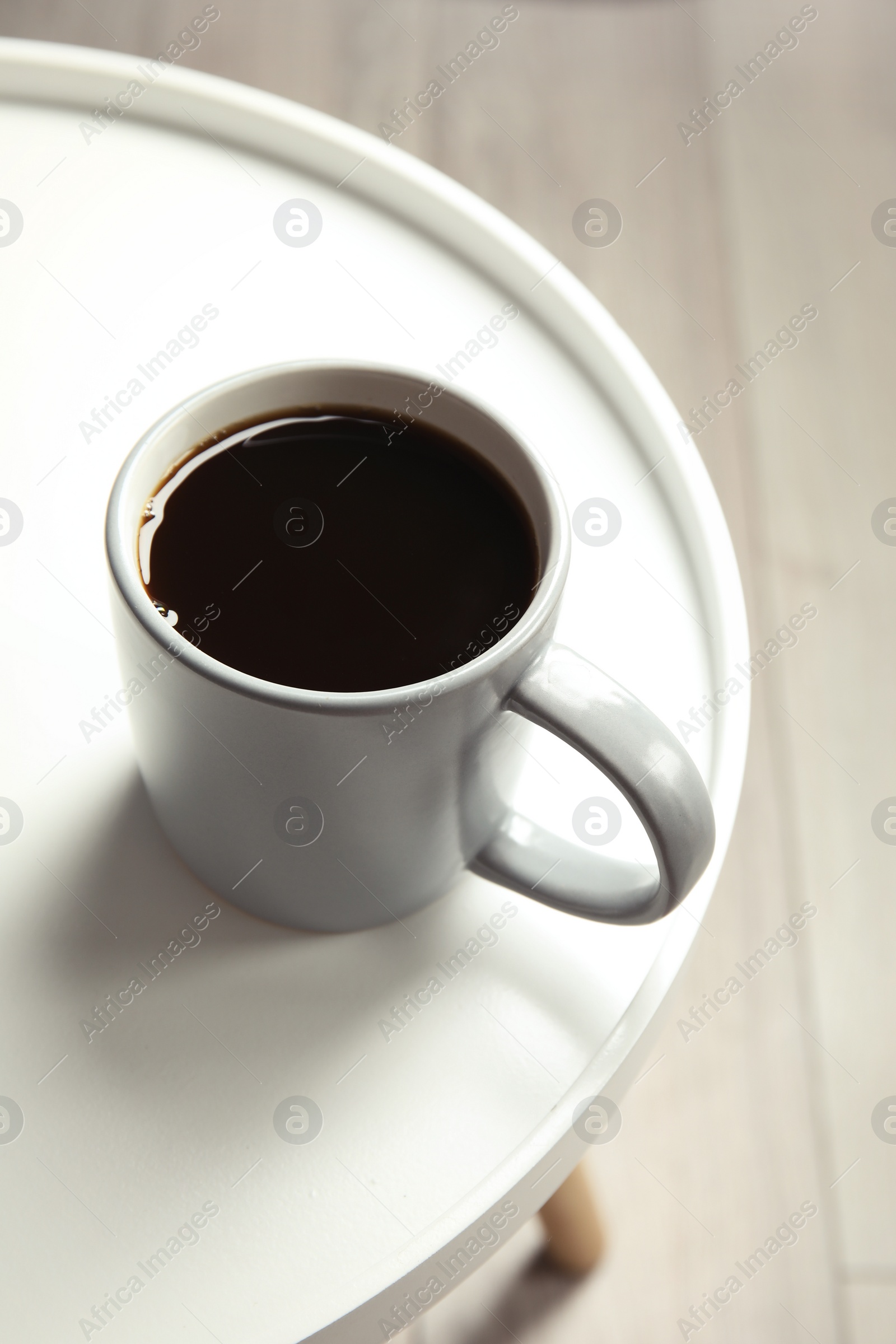 Photo of Cup of fresh aromatic coffee on light table. Food photography