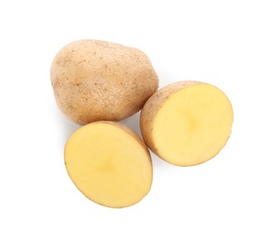 Whole and cut fresh potatoes on white background, top view