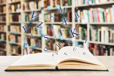 Open book with letters flying out of it in library