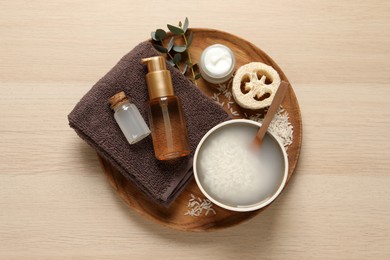 Photo of Flat lay composition with soaked rice on wooden table