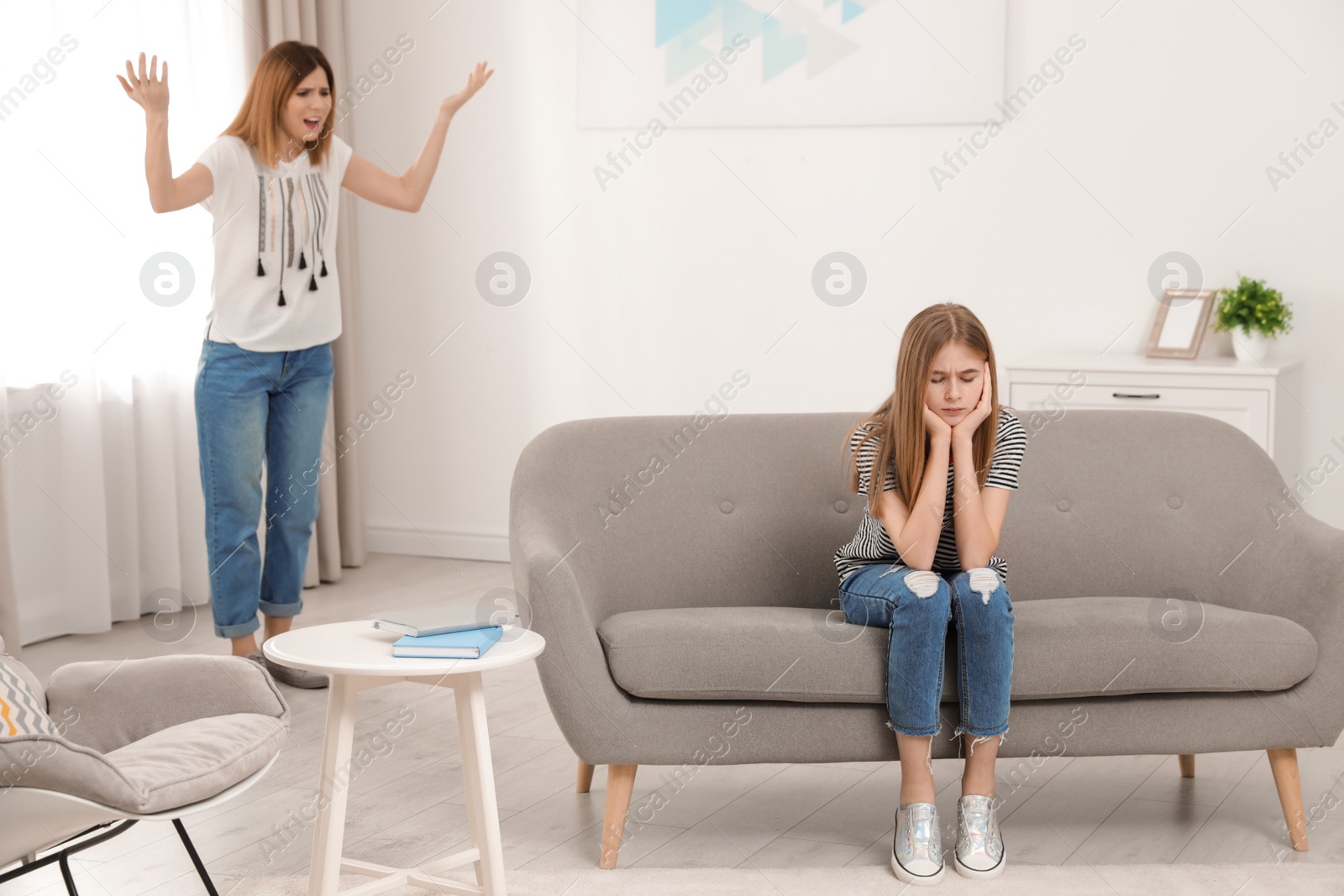 Photo of Mother scolding her teenager daughter at home