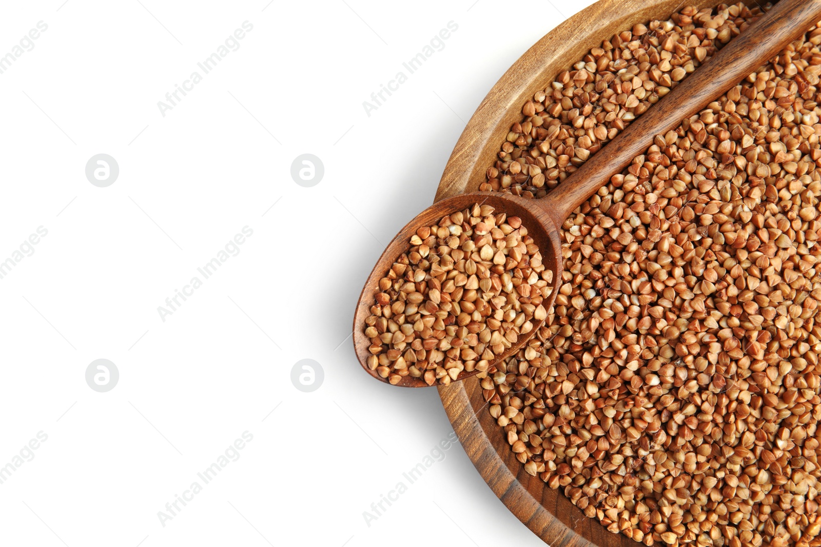 Photo of Bowl and spoon with uncooked buckwheat on white background, top view