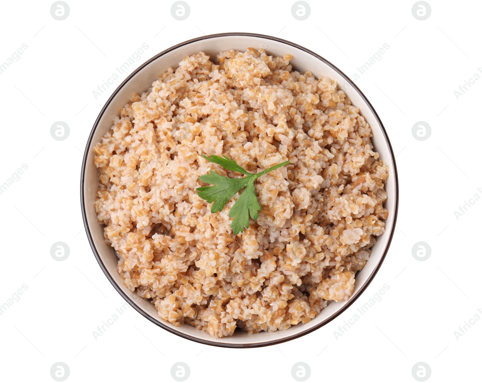 Photo of Tasty wheat porridge with parsley in bowl isolated on white, top view