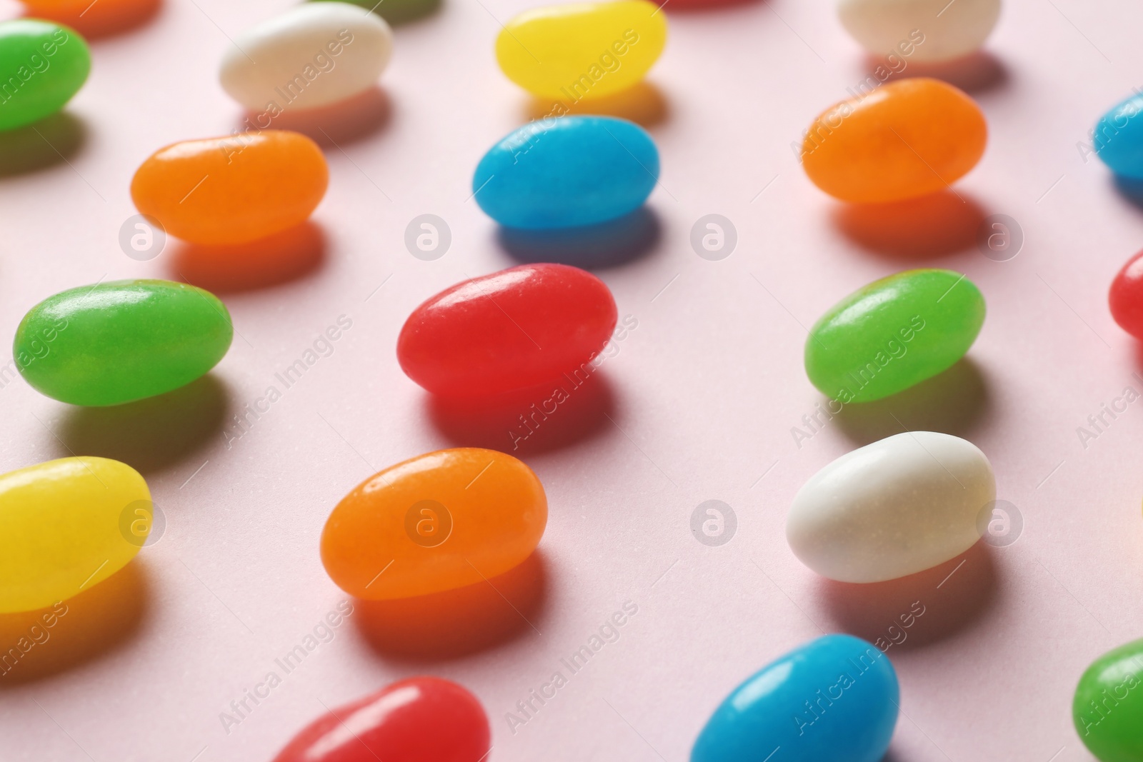 Photo of Bright jelly candies on color background, closeup