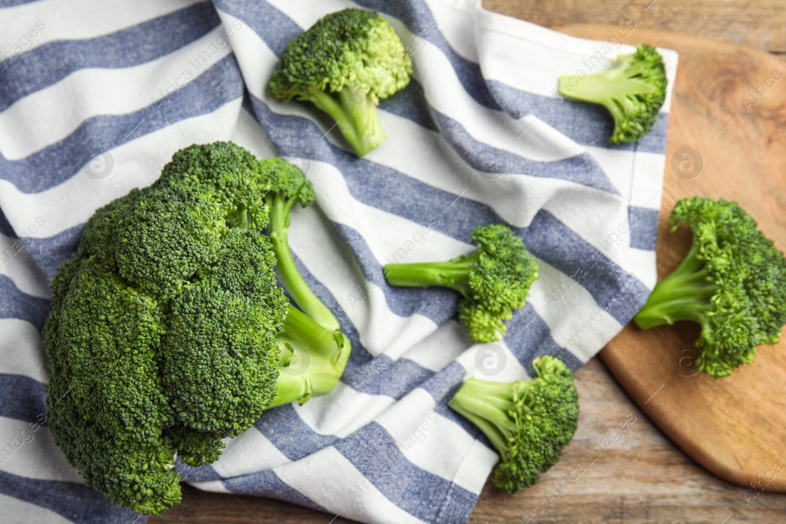 Photo of Fresh green broccoli on wooden table, above view. Organic food