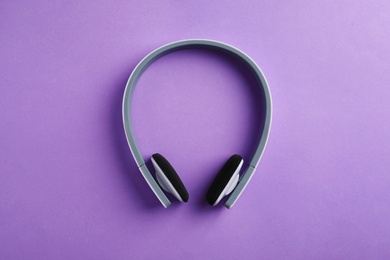 Photo of Wireless headphones on color background, top view