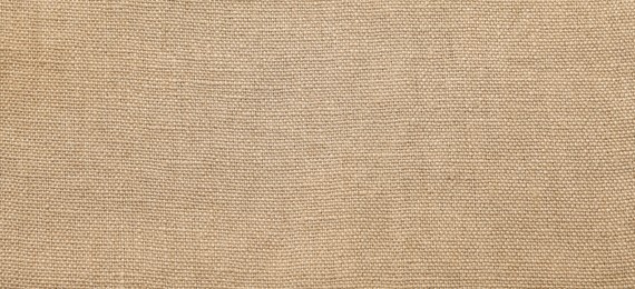 Photo of Texture of beige fabric as background, top view