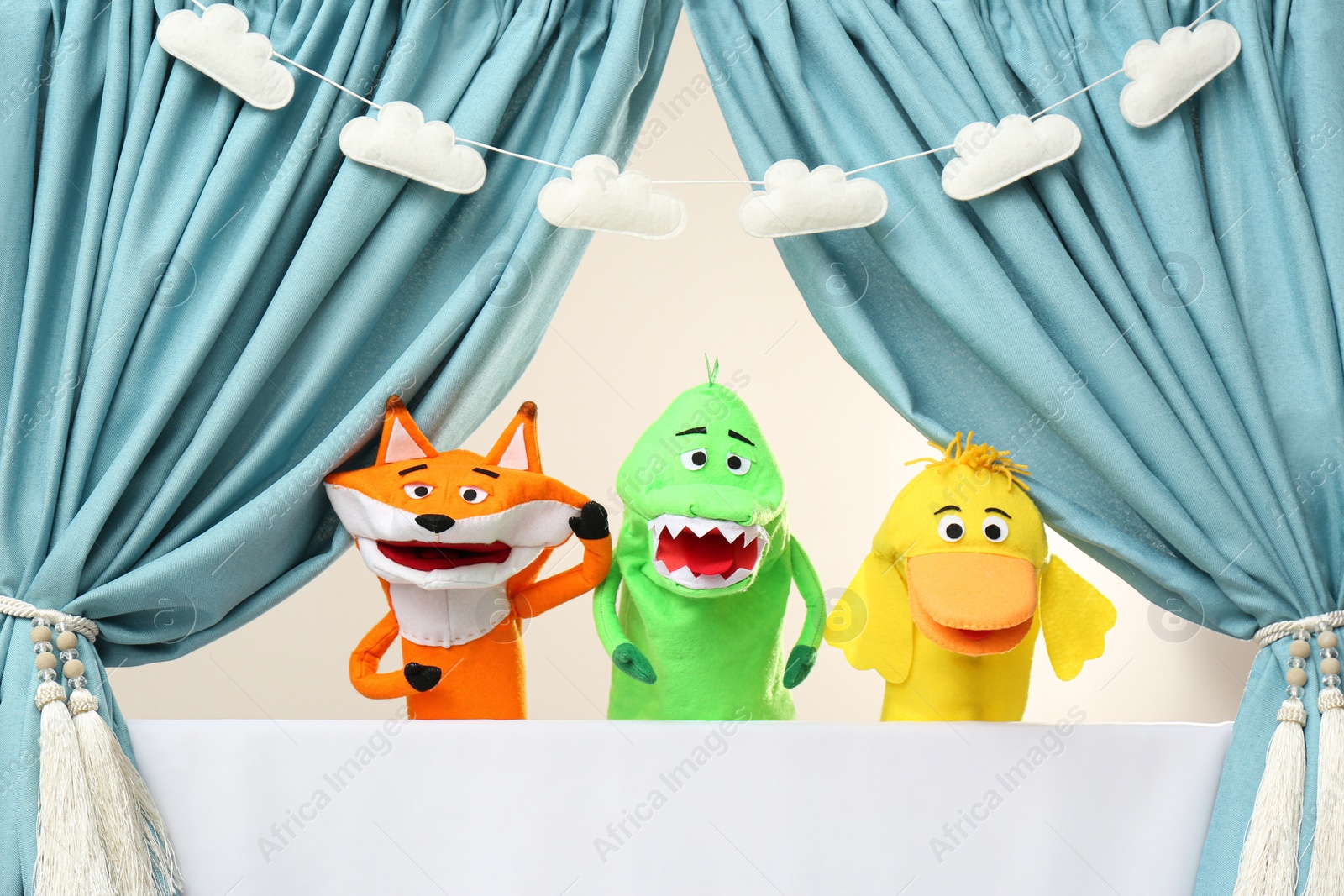 Photo of Creative puppet show on white stage indoors