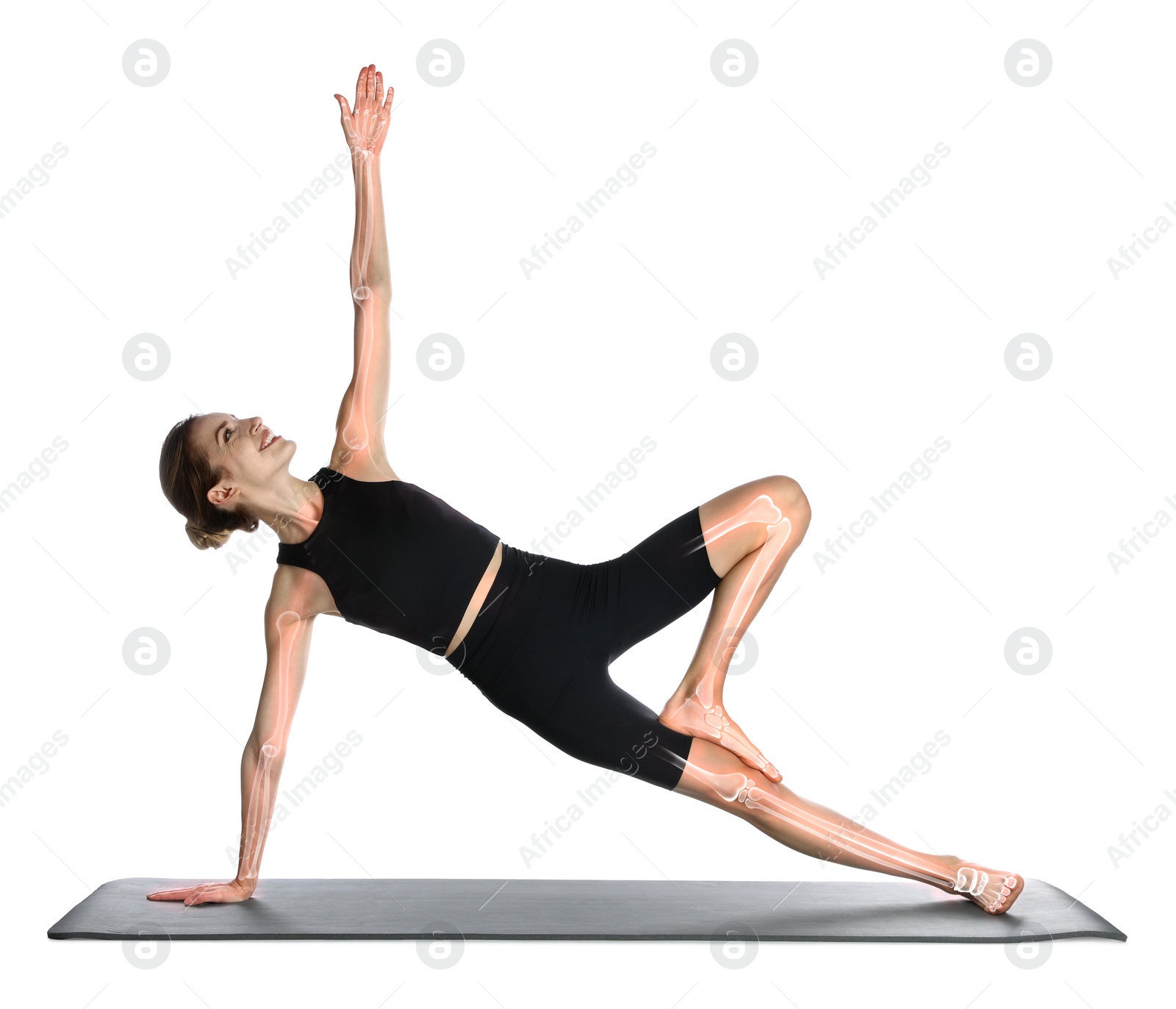 Image of Digital composite of highlighted bones and woman practicing yoga on white background
