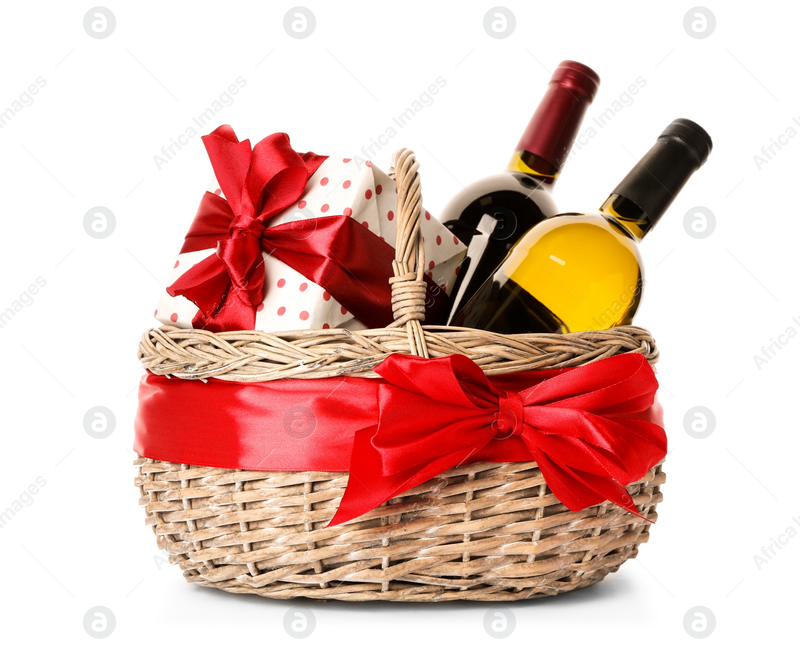 Photo of Festive basket with bottles of wine and gift on white background