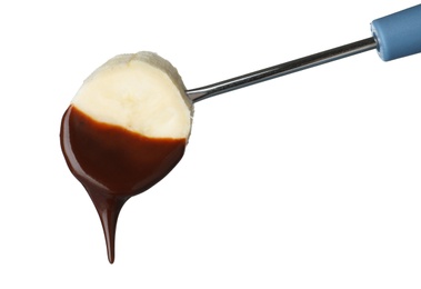 Photo of Banana with chocolate on fondue fork against white background