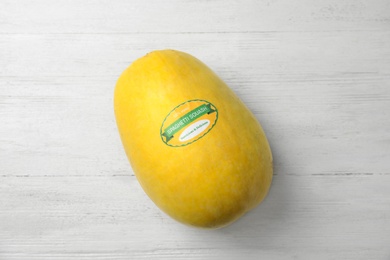 Whole ripe spaghetti squash on wooden background, top view
