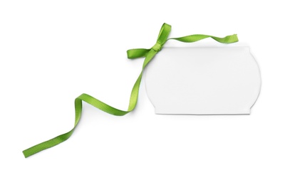 Photo of Blank gift tag with satin ribbon on white background, top view