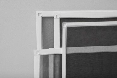 Set of window screens on light grey background, closeup