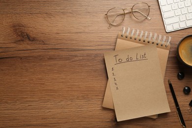 Flat lay composition with unfilled To Do list and glasses on wooden table, space for text