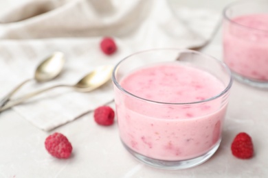 Photo of Delicious dessert with raspberries in glass on table