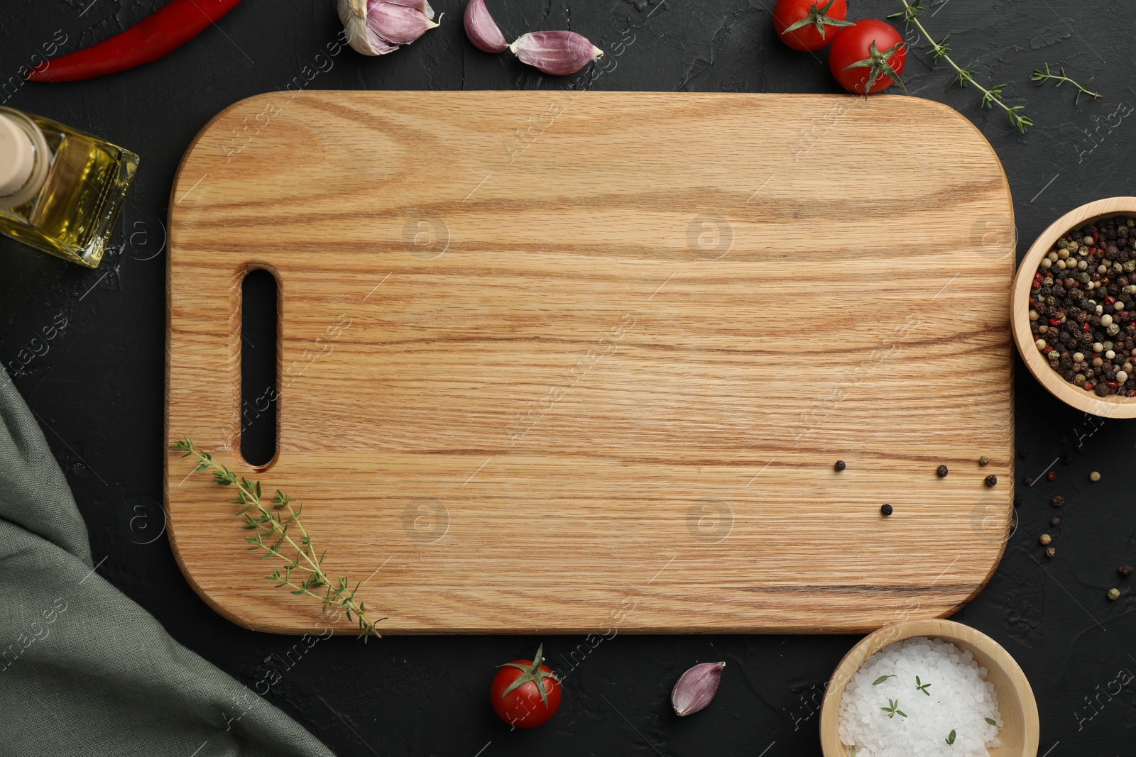 Photo of Cutting board, fresh tomatoes and different spices on grey textured table, flat lay