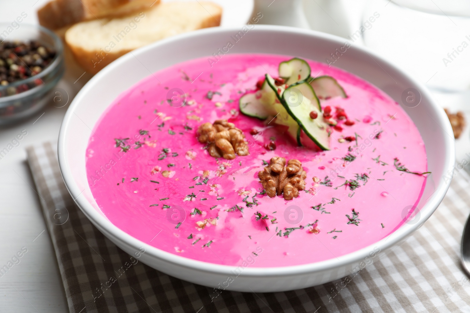 Photo of Delicious cold summer beet soup on table, closeup