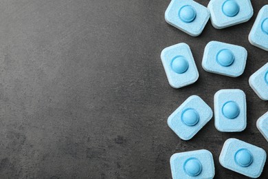 Photo of Water softener tablets on grey table, flat lay. Space for text