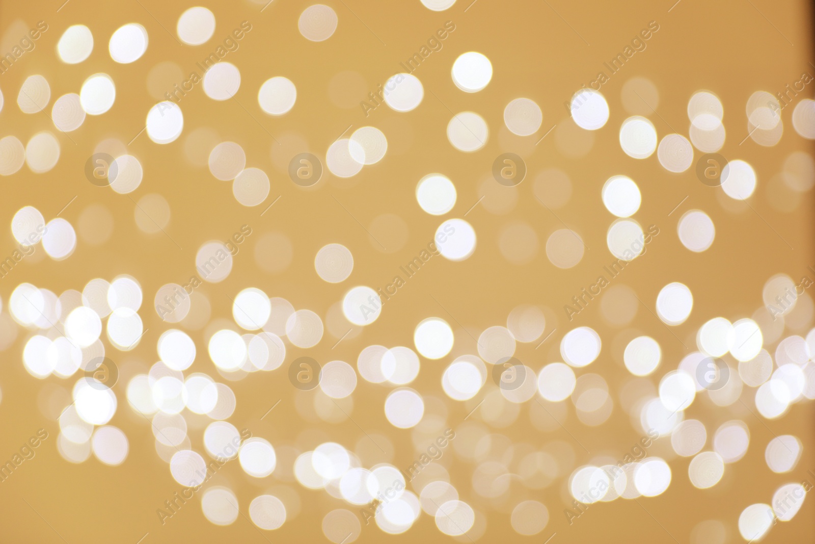 Photo of Blurred view of shiny silver lights. Bokeh effect