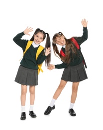 Photo of Little girls in stylish school uniform on white background