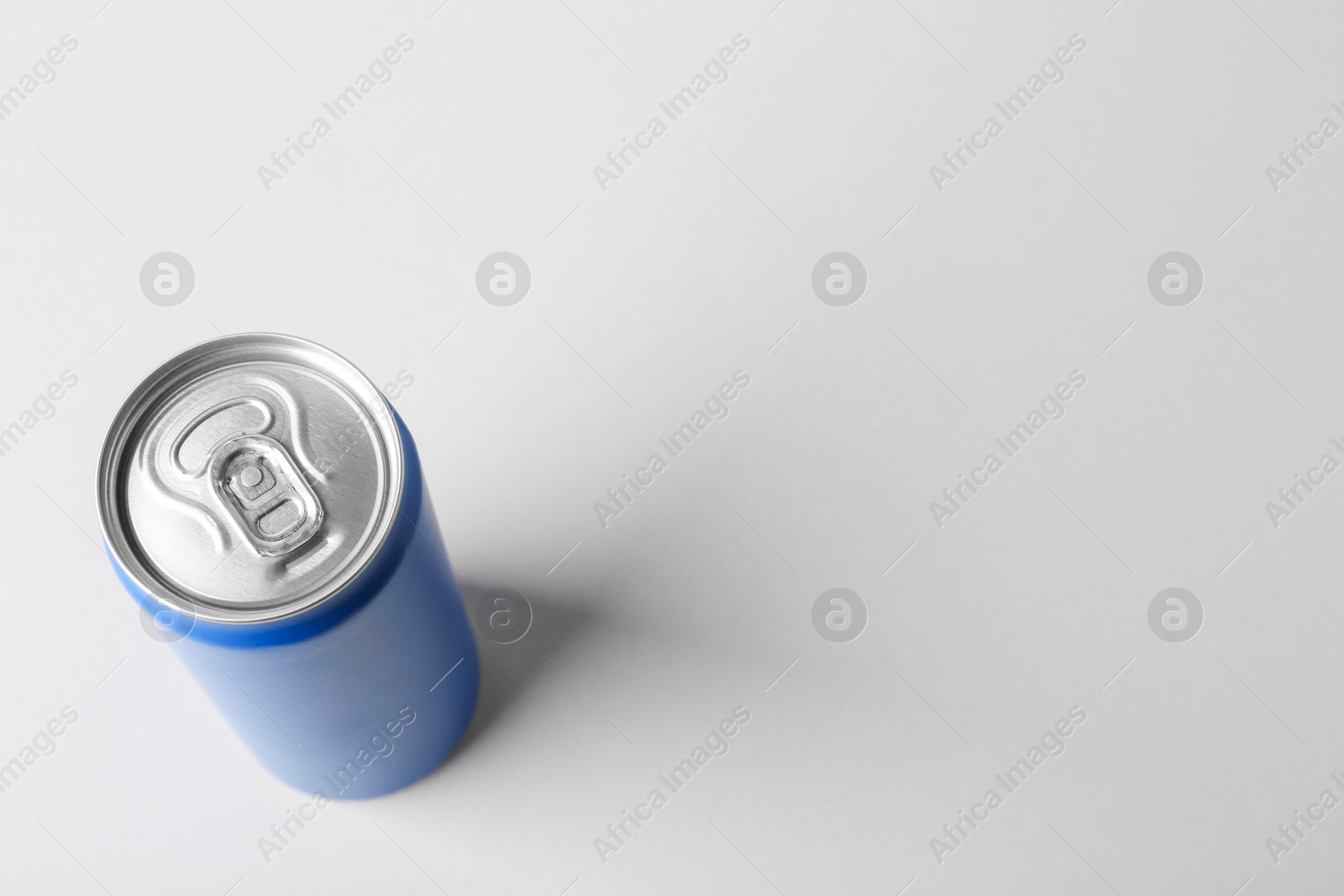 Photo of Energy drink in blue can on light grey background, above view. Space for text