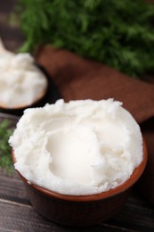 Photo of Delicious pork lard in bowl on wooden table, closeup