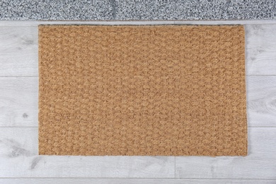 Photo of Door mat near stone stairs indoors, top view. Space for design