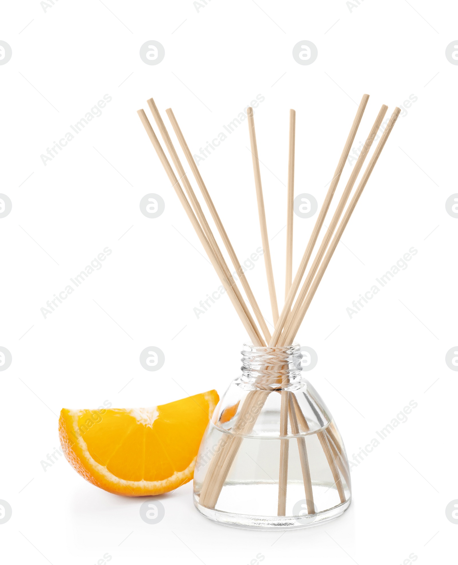 Photo of Aromatic reed freshener and slice of orange on white background