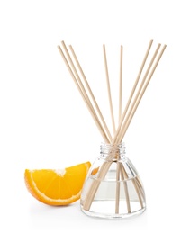 Photo of Aromatic reed freshener and slice of orange on white background